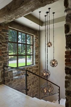 a room with stone walls and glass railings