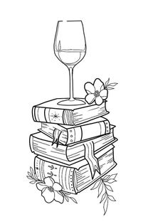 a stack of books and a glass of wine on top of each other with flowers