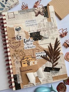 an open notebook covered in scrap paper and other decorative items next to a pair of scissors