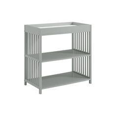 a white baby changing table with two shelves on each side and one shelf below it