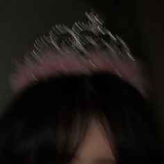 a blurry photo of a woman with a tiara on top of her head