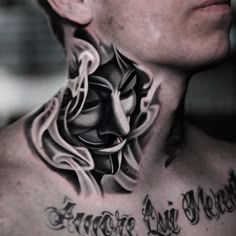 a man with tattoos on his neck and chest is looking at the camera while wearing a mask