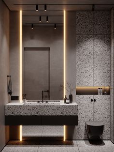 a modern bathroom with two sinks and lights on the wall above it's mirror