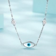 Channel effortless boho chic with this sterling silver evil eye choker necklace. Crafted from high-quality 925 sterling silver, this protective amulet features an evil eye charm embellished with sparkling cubic zirconia stones star beads on both sides that catch the light. Whether you're after a touch of Turkish style or want to ward off negative energy, this choker necklace is a stylish way to embrace the power of the evil eye. Slip it on to channel good vibes and make a statement with effortless, bohemian flair. Materials: 925 sterling silver, cubic zirconiaFinish: platinum plateNecklace length: 13.5 in + 3 in extension chain Jewelry Care: See more information about how to care for your jewelry here. Shipping Policy: Orders will be shipped within 1-3 business days. Economy shipping will Dainty Silver Necklace With Evil Eye, Sterling Silver Necklaces With Diamond Eyes, Elegant Silver Evil Eye Charm Necklace, Sterling Silver Evil Eye Necklaces, Adjustable Silver Evil Eye Necklace, Silver Symbolic Evil Eye Necklace, Blue Metal Necklace With Evil Eye, Blue Evil Eye Metal Necklace, Blue Metal Evil Eye Necklace