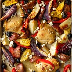 a pan filled with chicken and vegetables covered in feta cheese, olives, peppers