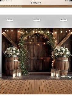 an image of a website page with flowers and lights on the front, and behind it is a wooden barrel