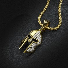 This solid gold and half paved diamond Spartan pendant is a symbol of Strength, Courage, Loyalty, and Power. The Yellow Gold Spartan Pendant was created for Free Men who demand the most of themselves and break the shackles of society. The inside of the helmet is beautifully sculpted with a Spartan shield and Spartan warriors bearing the swords. MATERIALS, WEIGHTS & MEASUREMENTS: Small Size: 14 karat gold weight is 11 grams and 18 karat gold weight is 13 grams. 55 VVS Colorless diamonds totaling Mens Gold Pendant, Spartan Shield, Symbol Of Strength, Anime Jewelry, Colorless Diamond, Mens Pendant, Mens Gold, Pave Diamonds, Diamond Pendant