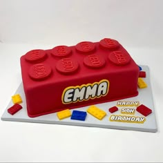 a birthday cake made to look like a lego block with the name ema on it