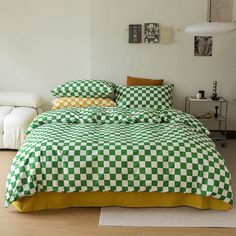 a green and white checkered comforter on a bed