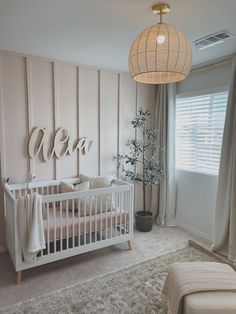 a baby's room with a white crib and pink walls