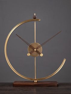 a golden clock on a wooden stand