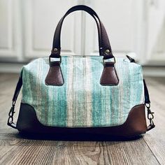 a purse sitting on the floor in front of a cabinet