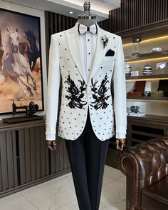 Make an edgy statement with White EMBROIDERED suit designed thoughtfully for the modern  man. A fusion staple fit for every occasion, adds the right amount of cultural twist to the western silhouette. Color: white Garment Type: Indo Western Neck: tuxedo Fabric: Micro Velvet Embroidery: Zari work with sequin embroidery The Product Price is inclusive of: 1 Indo-Western and 1 Trouser Style Bottom and 1 shirt Product color may slightly vary due to photographic lighting sources or your screen setting Black Jodhpuri, White Tuxedo Wedding, Embroidered Tuxedo, Floral Suit Jacket, Tuxedo White, Fancy Suits, Wedding Suits Men Black, Western Silhouette, Indian Jackets