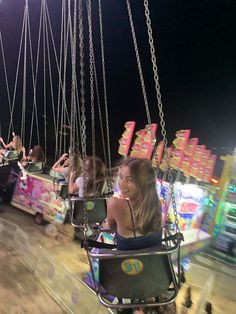 people ride on swings at an amusement park