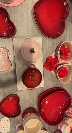 red dishes and cups are arranged on a table