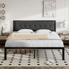 a large bed sitting on top of a white floor next to a dresser and lamp