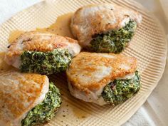 four pieces of chicken with broccoli and cheese on a plate