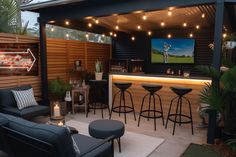 an outdoor bar with stools and lights on the roof is lit up at night