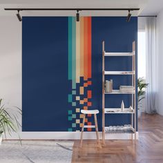 a room with a blue wall and colorful stripes on the wall, along with a ladder