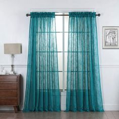 the curtains are hanging in front of a window