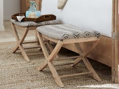 two wooden benches sitting next to each other on top of a carpeted bedroom floor