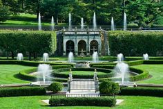 an ornate garden with fountains in the middle