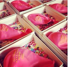 six boxes filled with pink and gold confetti covered cakes in it's packaging