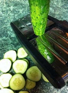 the cucumber is being cut into slices with a juicer on the side