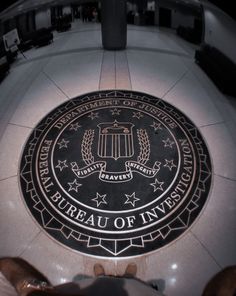 the seal of the bureau of invest is shown in front of a circular floor sign