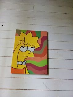 the simpsons painting is hanging on the wall