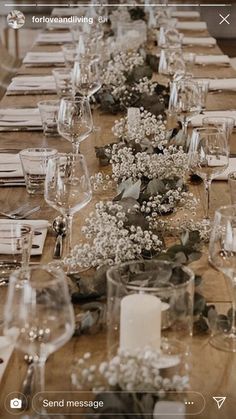 the table is set with many glasses and place settings for dinner guests to sit at