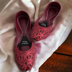 Introducing our exquisite Handmade Maroon Khussa with Tilla and Cutwork - a true testament to artistry and comfort. Each pair of these stunning shoes is meticulously crafted by skilled artisans, ensuring the highest level of quality and attention to detail. The rich maroon color, combined with intricate tilla (maroon reshom) and cutwork embroidery, makes these Khussas a perfect fusion of tradition and contemporary style. They exude elegance and sophistication, making them ideal for special occasions or everyday wear. But that's not all; we understand the importance of comfort. That's why we've designed these Khussas with a double-padded sole. You can now enjoy the beauty of these shoes without compromising on comfort. Whether you're walking down the aisle or strolling through a garden, you Cut Dana Flats For Diwali, Festive Cut Dana Flats For Diwali, Navratri Closed Toe Flats With Dori Work, Traditional Flats With Cut Dana For Festive Occasion, Festive Cutdana Closed Toe Flats, Festive Closed Toe Flats With Cutdana Details, Navratri Closed Toe Flats, Closed Toe Flats For Navratri, Festive Cut Dana Flats With Round Toe