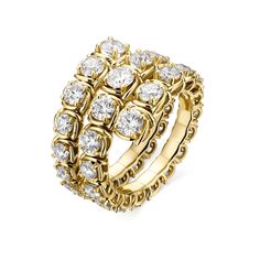 a yellow gold ring with white stones on it's center and two rows of smaller diamonds in the middle