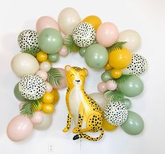 the balloon arch is decorated with balloons and a cheetah figurine