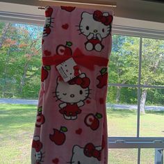 the hello kitty towel is hanging in front of a window