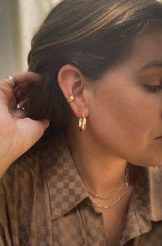 Give your earring stack a bold, eye-catching look with our floral cuff. A most-loved piece for good reason. With a delicate floral design and 4 mm width, it’s the perfect balance of minimal and statement. How to place an ear cuff: Start by sliding the ear cuff over the top part of our ear ( the thinnest cartilage part) then slide down onto the lower conch. Gently tug to make sure it does not come off. Depending on the cuff, it may be able to be squeezed for a tighter fit. Cartilage Cuff Earrings, Everyday Pierced Ear Cuff, Trendy Everyday Ear Climbers, Classic Pierced Ear Cuff, Modern Huggie Piercings For Everyday, Modern Everyday Huggie Piercings, Trendy Hypoallergenic Ear Cuff For Everyday Wear, Modern Huggie Ear Cuff, Modern Adjustable Cartilage Earrings For Everyday Wear