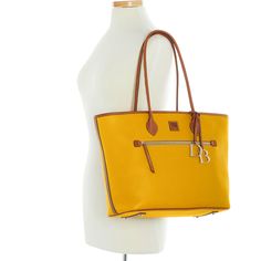 Tote It All    This essential tote, made from pebble leather with a natural grain that hides any imperfections, makes a great work bag for anyone who has a lot to carry to and from the job. Yellow Textured Leather Travel Bag, Dooney & Bourke, Work Bag, Large Tote, Dooney Bourke, Hermes Birkin, Pebbled Leather, Top Handle Bag, Im Not Perfect