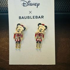 a pair of disney character earrings on display