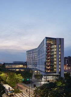 an office building in the evening with street lights