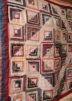 an old quilt is hanging on the wall