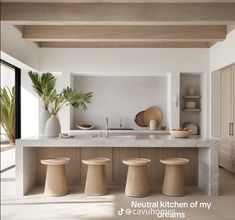 the kitchen is clean and ready to be used for cooking or entertaining, with stools around the island