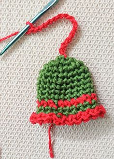 a crocheted christmas ornament with a red and green hat on it