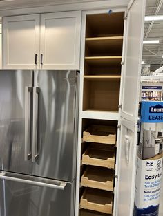 a stainless steel refrigerator and pantry in a store