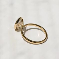 a gold ring with a diamond on it