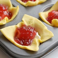 small pastries filled with jelly on top of a pan