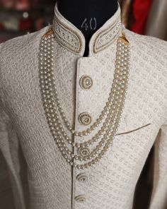 a mannequin is adorned with pearls and beads