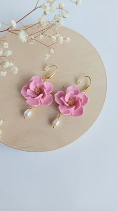 pink flower earrings with pearls on them