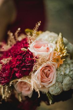 a bridal bouquet with pink and red flowers