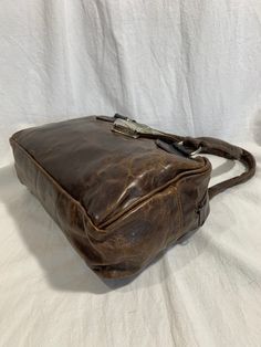 "Measurements are 11\" wide, 8\" high, 3\"2 deep with two 19\" handles each. On the interior there is one main compartment with a back zipper pocket, lined in brown leather with a top zipper and a front closure. The overall condition of this brown leather bag with lizard trim is in good condition for it's age and was well cared for. -----------------------------------------I SHIP WORLDWIDE------------------------------------------------- I want to stress that item is vintage which means it's not Distressed Brown Leather-lined Satchel Shoulder Bag, Brown Saddle Bag With Top Carry Handle, Formal Vintage Brown Leather Satchel, Vintage Brown Top Handle Saddle Bag, Brown Satchel With Leather Backing And Top Handle, Distressed Brown Satchel For Travel, Brown Satchel Saddle Bag With Leather Lining, Brown Satchel With Leather Lining And Double Handle, Brown Leather Top Handle Satchel