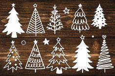 christmas trees cut outs are shown on a wooden surface